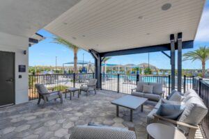 RISE Citrus Ridge elevated design townhomes in Davenport, Florida: Outdoor Patio Lounge with Pool in background