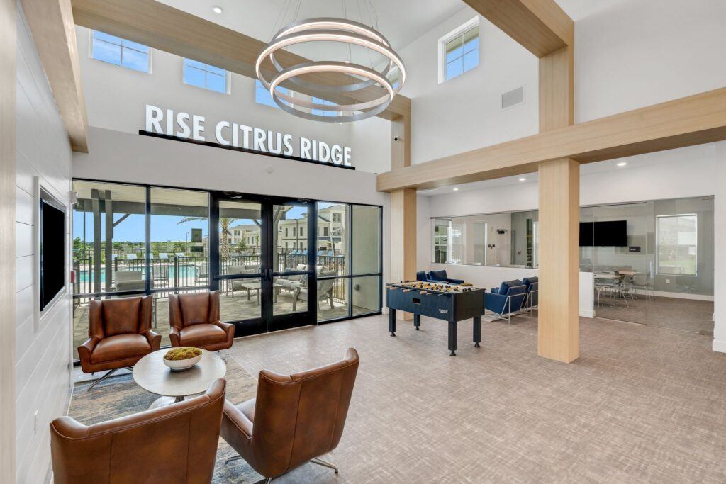 RISE Citrus Ridge elevated design townhomes in Davenport, Florida: Clubhouse Lobby Pool Entrance with Foosball Table 2