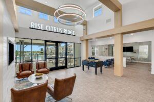 RISE Citrus Ridge elevated design townhomes in Davenport, Florida: Clubhouse Lobby Pool Entrance with Foosball Table 2