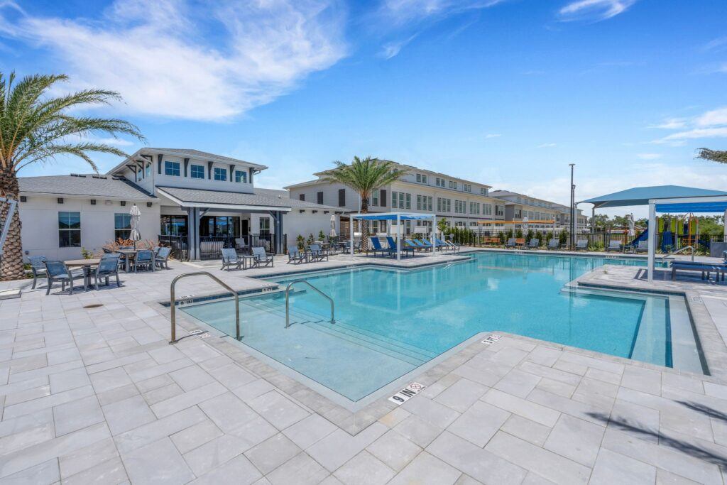 RISE Citrus Ridge elevated design townhomes in Davenport, Florida pool with lounge area and playground