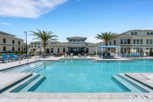 RISE Citrus Ridge elevated design townhomes in Davenport, Florida pool with lounge area and playground 2