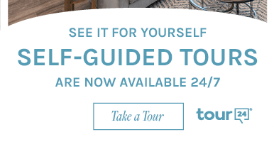 Modern kitchen and living area promoting 24/7 self-guided tours. Book a visit to explore this inviting space today.